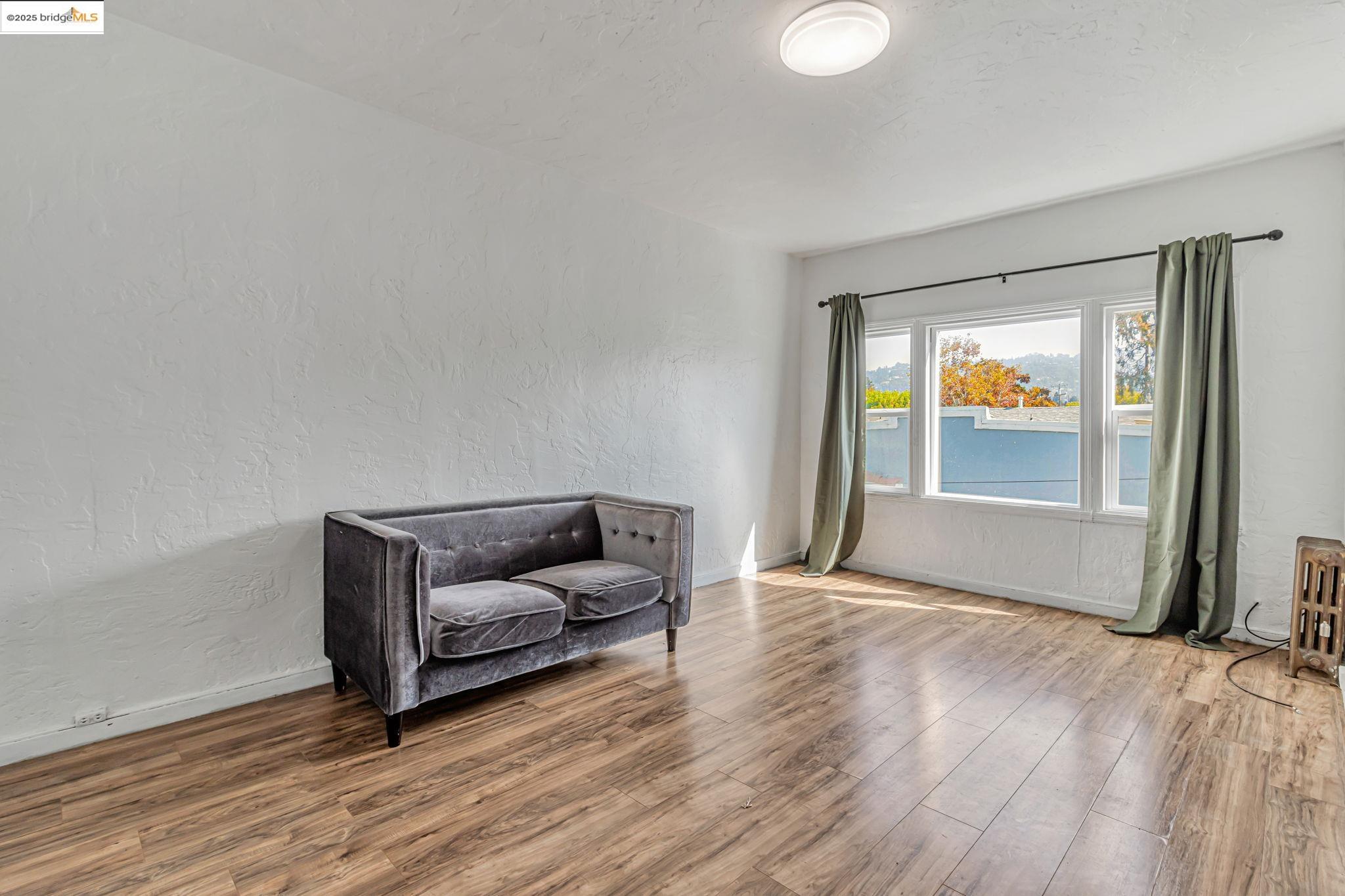 1360 Berkeley Way Berkeley, CA 94702 - Photo 27 of 35 a living room with furniture and a window