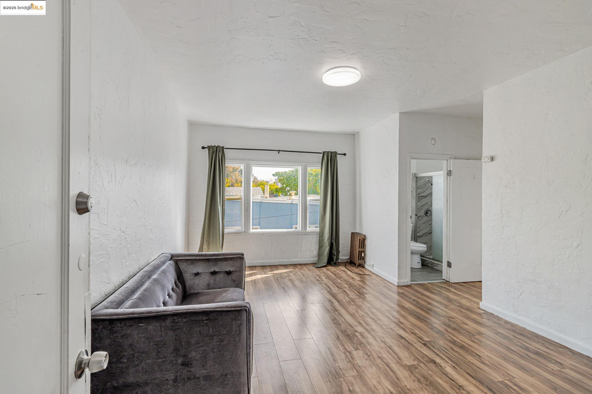 1360 Berkeley Way Berkeley, CA 94702 - Photo 28 of 35 a view of a room that has a bed and a window in it