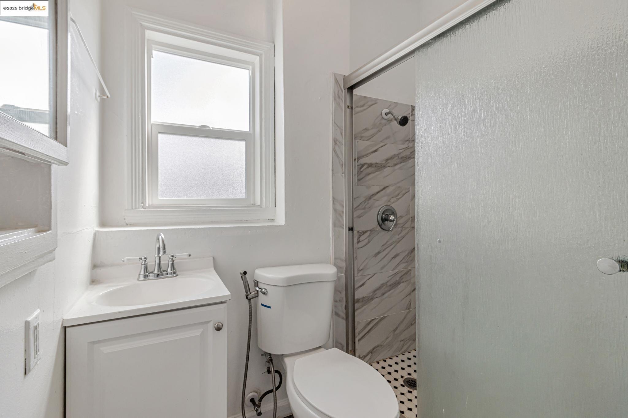 1360 Berkeley Way Berkeley, CA 94702 - Photo 6 of 35 a bathroom with a toilet sink vanity and mirror