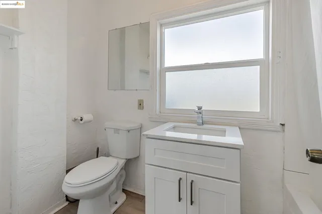 a bathroom with a sink toilet and a mirror