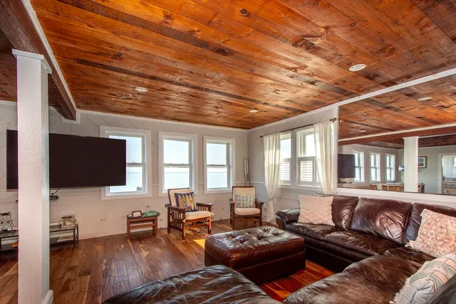 a living room with furniture a fireplace and a table