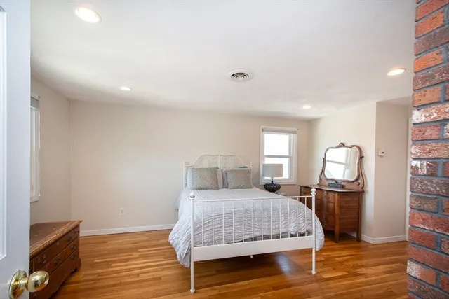 a bedroom with furniture and a window