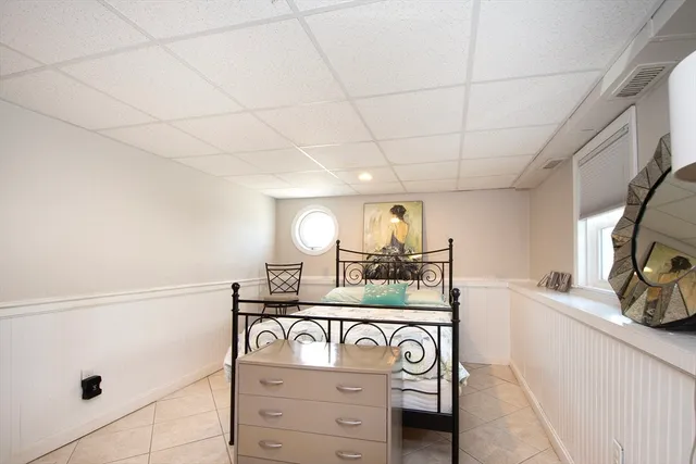 a bedroom with a bed and a chair