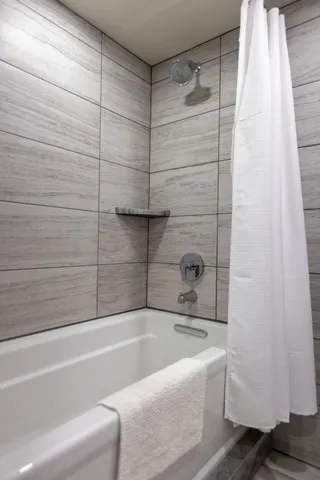 a view of a patio with couches and table and chairs and potted plants