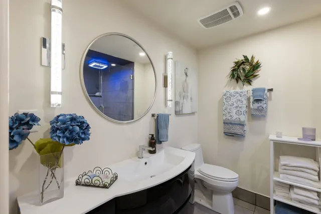 a living room with furniture a flat screen tv and a table