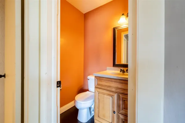 a bathroom with a toilet sink and mirror