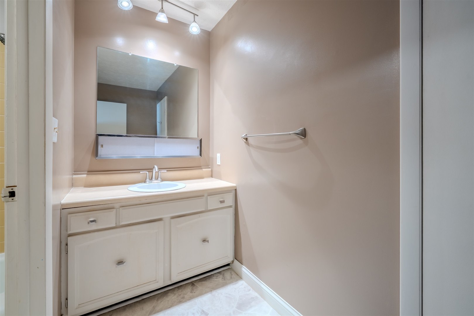 1402 Keller Road, Unit 4 Normal, IL 61761 - Photo 18 of 26 a bathroom with a sink a light fixture a vanity and a mirror