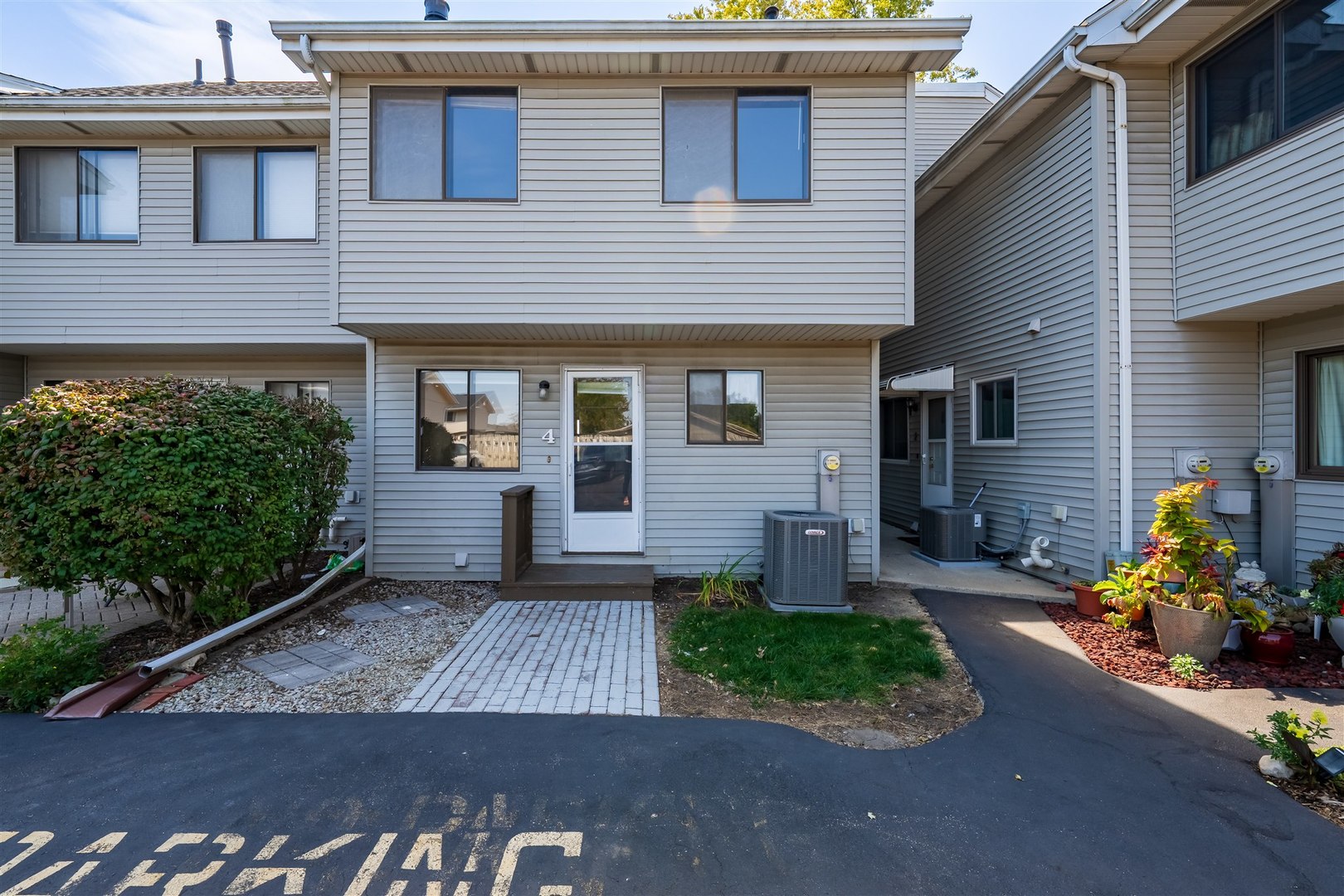 1402 Keller Road, Unit 4 Normal, IL 61761 - Photo 22 of 26 a front view of a house with garden