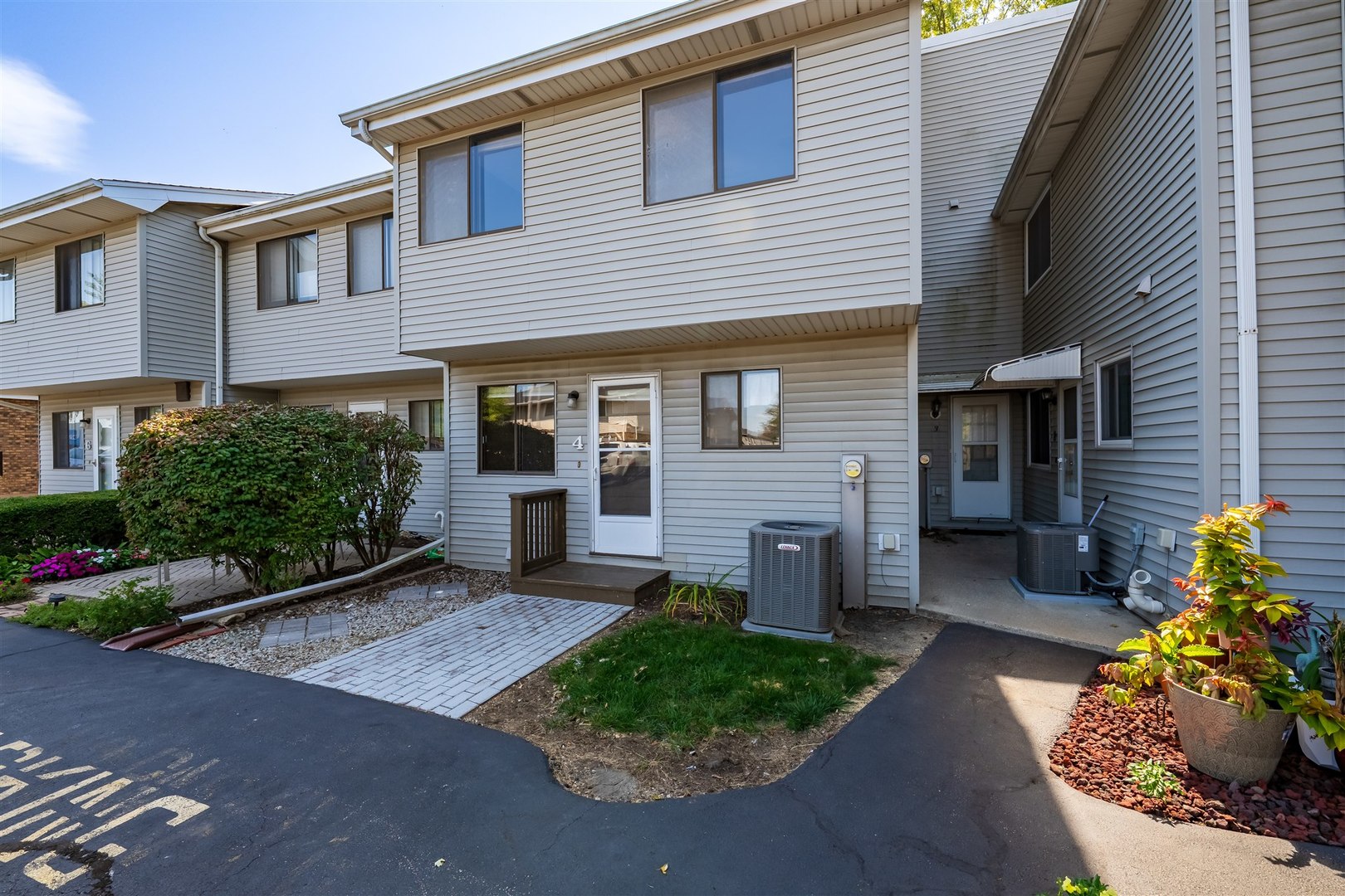1402 Keller Road, Unit 4 Normal, IL 61761 - Photo 23 of 26 a front view of a house with a garden and plants