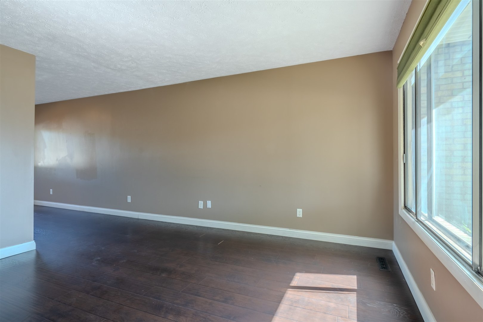 1402 Keller Road, Unit 4 Normal, IL 61761 - Photo 5 of 26 a view of an empty room with wooden floor and a window