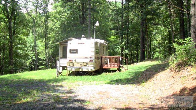 1174 Orchard Road Deep Gap, NC 28618 - Photo 1 of 7 a front view of a house with garden