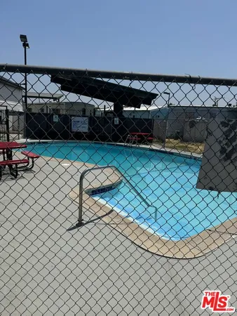 a roof deck with table and chairs
