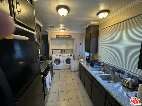 a kitchen with a sink appliances and cabinets