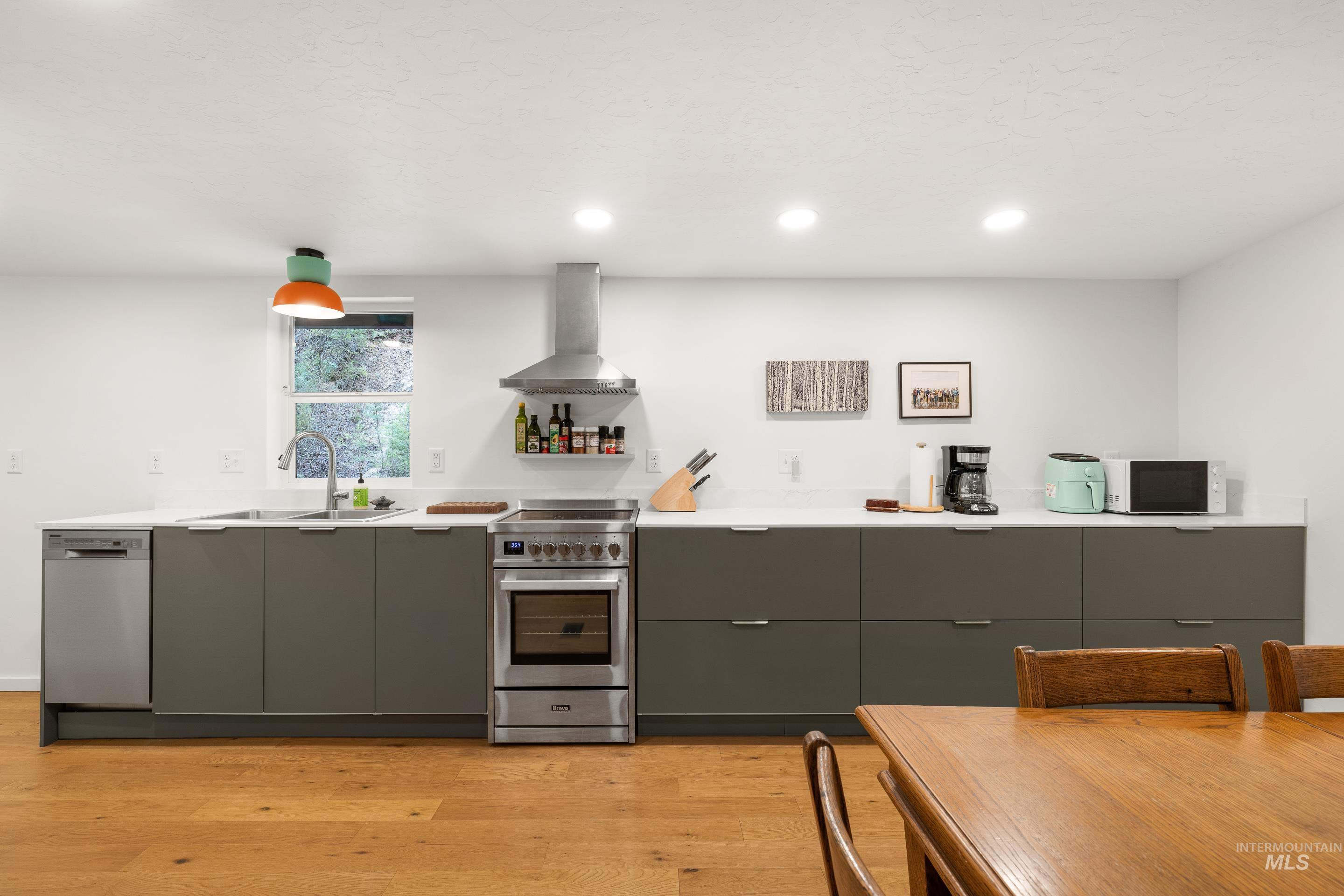 32 Sky Ridge Drive Garden Valley, ID 83622 - Photo 14 of 37 Kitchen with modern cabinets, stainless steel appliances, light wood-type flooring, gray cabinets, and recessed lighting