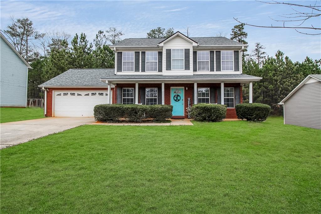 205 Whistle Way Locust Grove, GA 30248 - Photo 1 of 1 a front view of a house with a garden