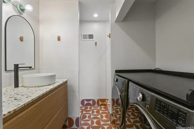 a bathroom with a granite countertop sink and a mirror
