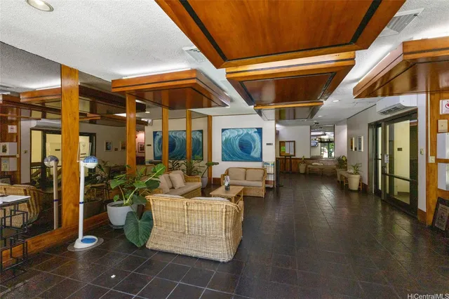 a living room with couches and coffee table with wooden floor