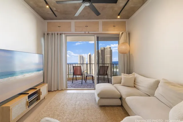 a living room with furniture a refrigerator and a flat screen tv