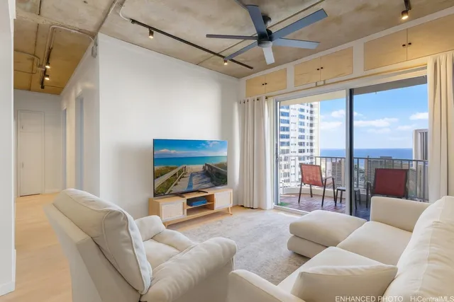 a living room with furniture and a floor to ceiling window