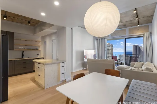 a large kitchen with stainless steel appliances a stove a table and chairs