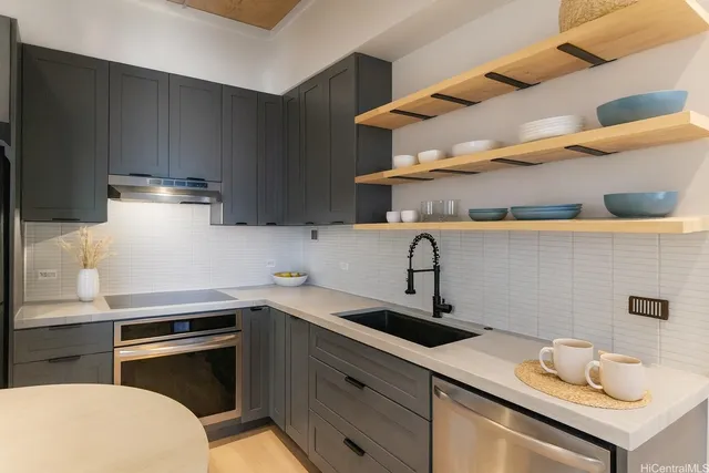 a kitchen with a sink cabinets and appliances