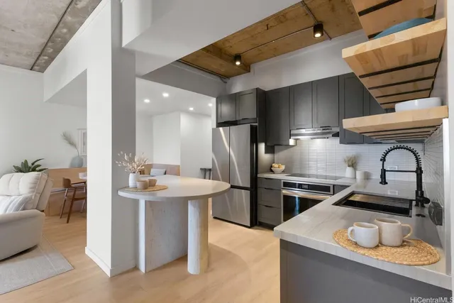 a kitchen with stainless steel appliances granite countertop a sink stove and refrigerator