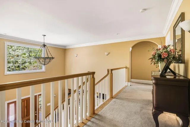 a kitchen with stainless steel appliances kitchen island granite countertop a stove top oven a sink a dining table and chairs with wooden floor