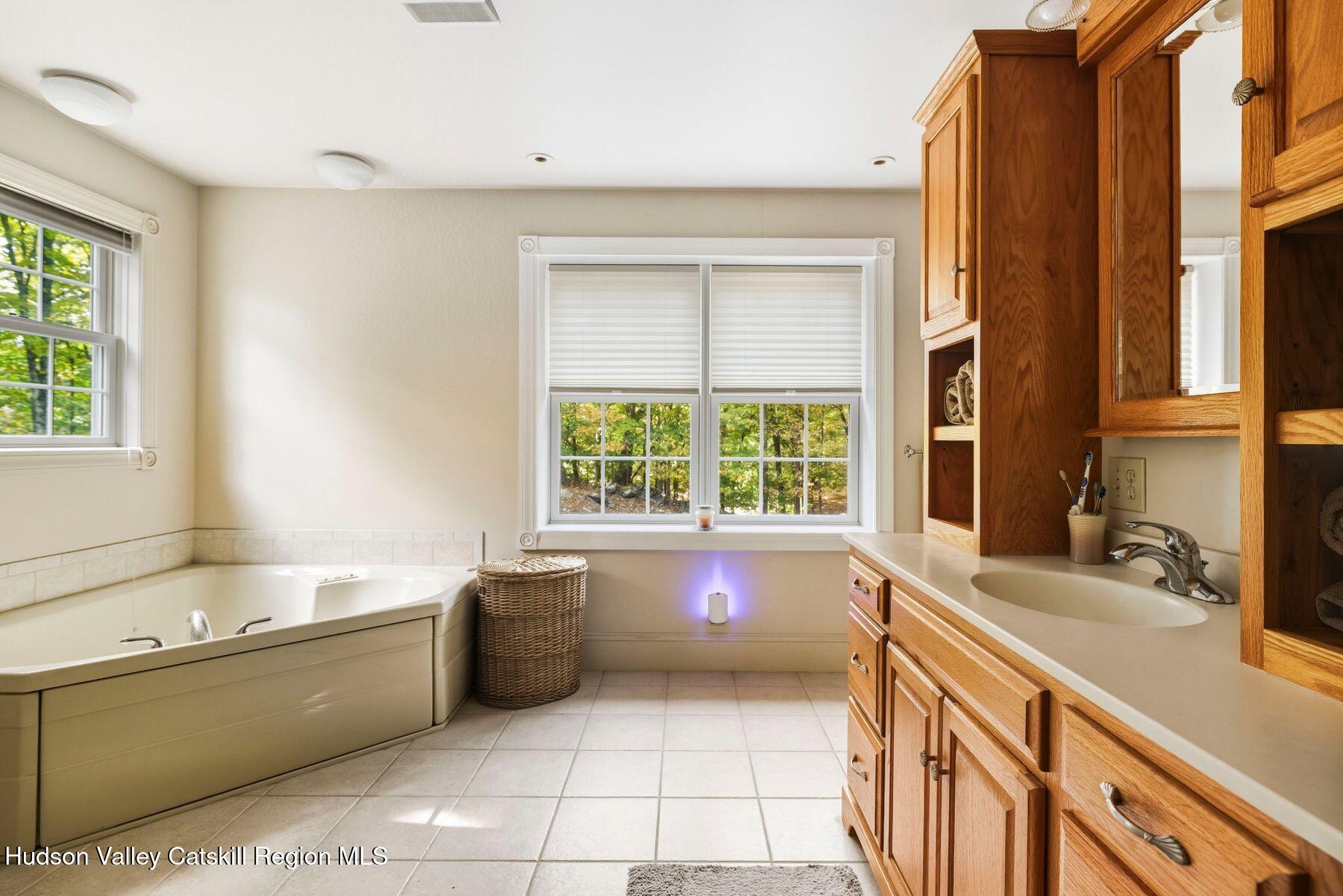 74 Bellevue Road Highland, NY 12528 - Photo 22 of 65 a bath tub sitting in a bathroom next to a window