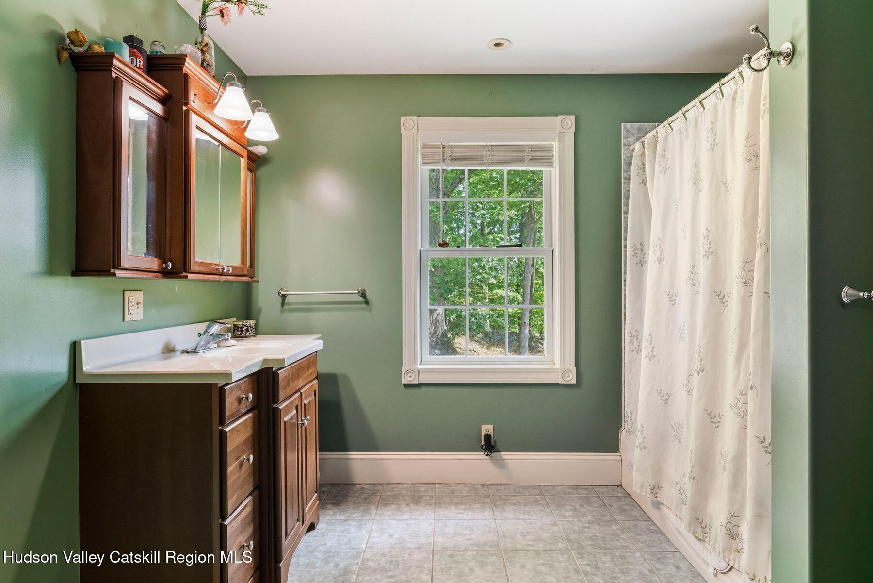 74 Bellevue Road Highland, NY 12528 - Photo 25 of 65 a view of a bathroom with a sink and mirror
