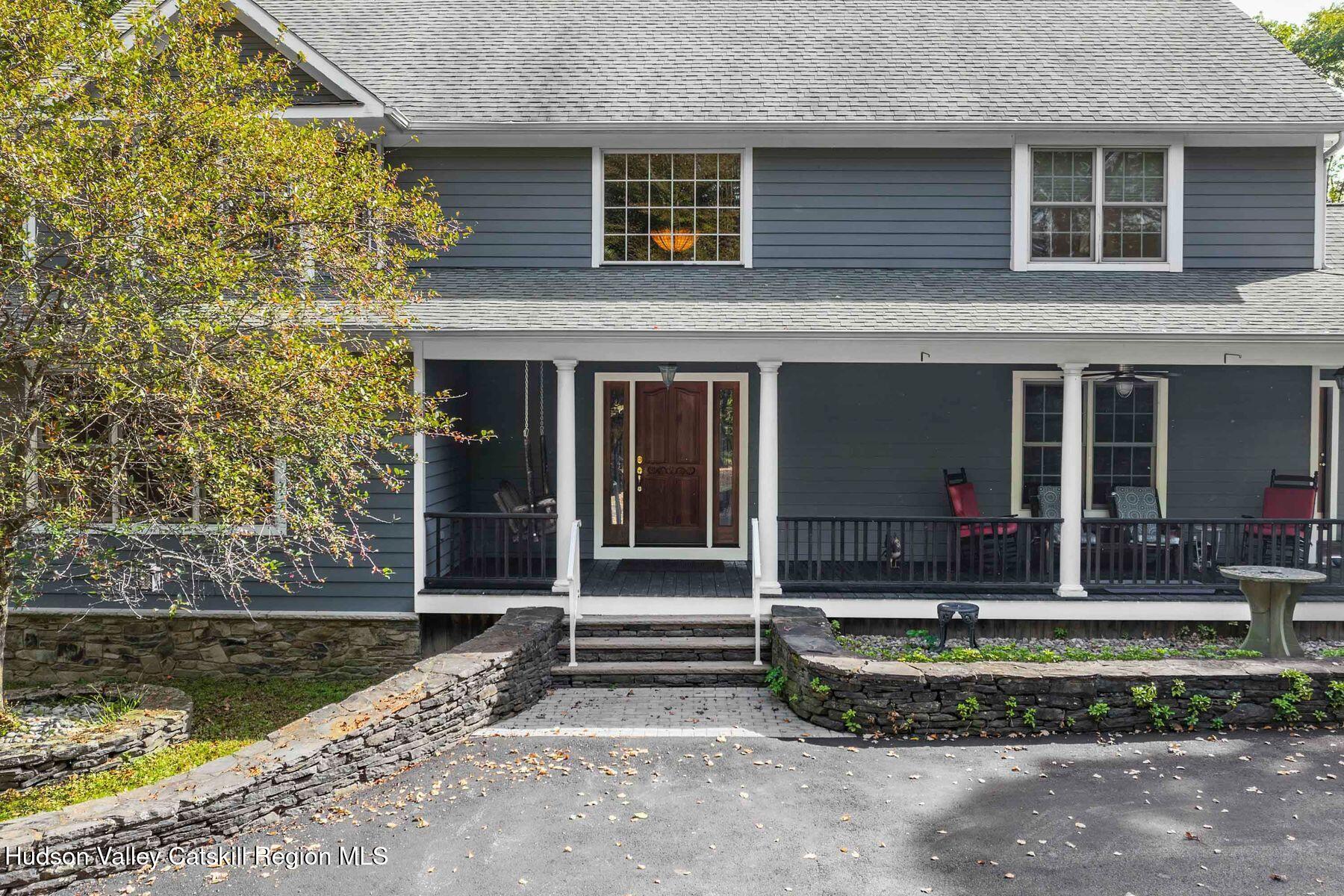 74 Bellevue Road Highland, NY 12528 - Photo 3 of 65 a front view of a house with a yard and potted plants