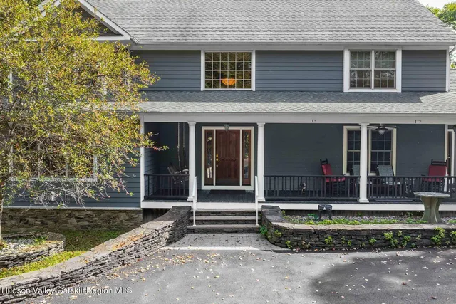 a view of a livingroom with wooden floor and a large window