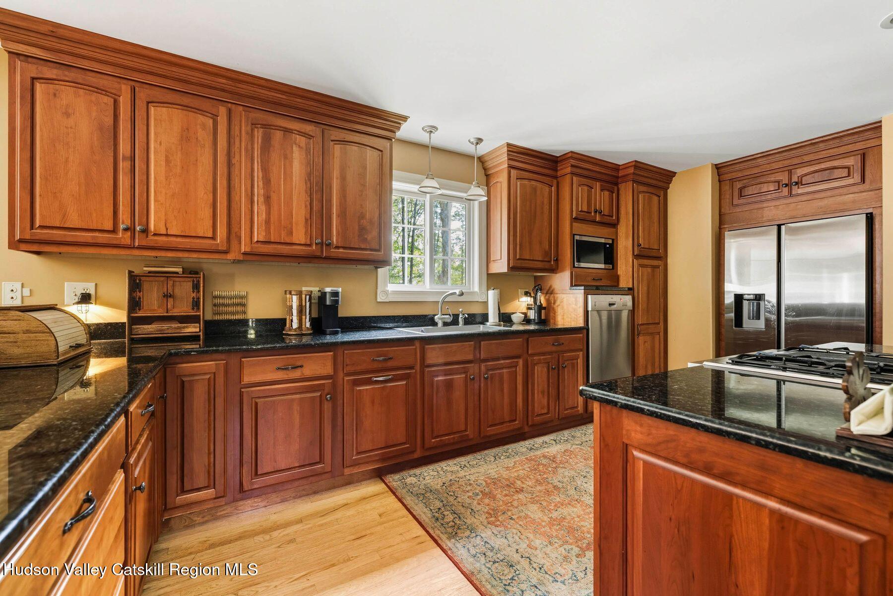 74 Bellevue Road Highland, NY 12528 - Photo 51 of 65 a kitchen with stainless steel appliances granite countertop a sink stove and cabinets