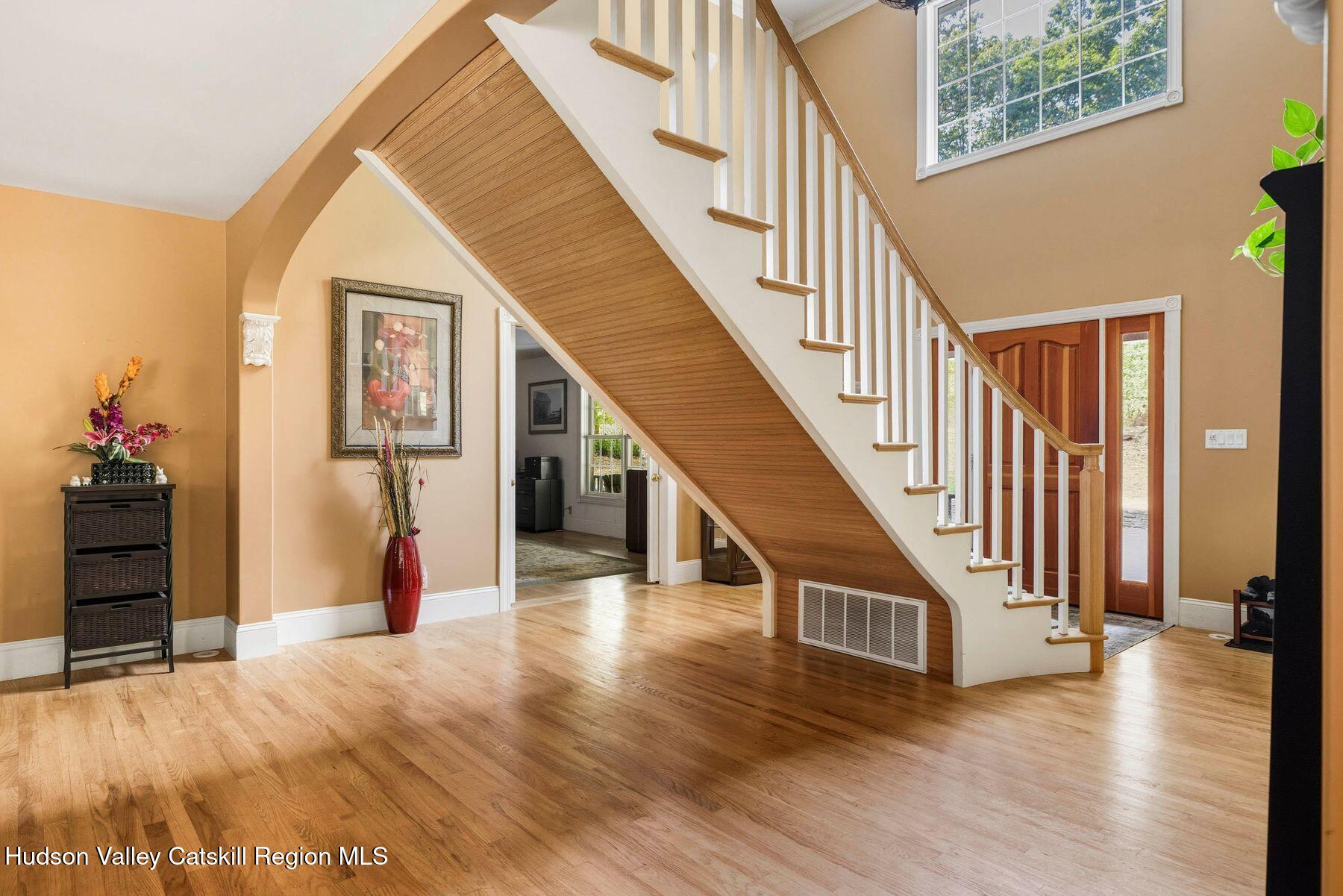 74 Bellevue Road Highland, NY 12528 - Photo 7 of 65 a view of a hallway with wooden floor and staircase