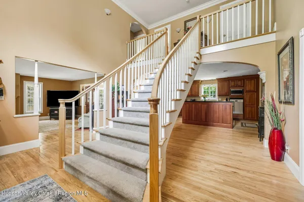 a view of entryway and hall with wooden floor