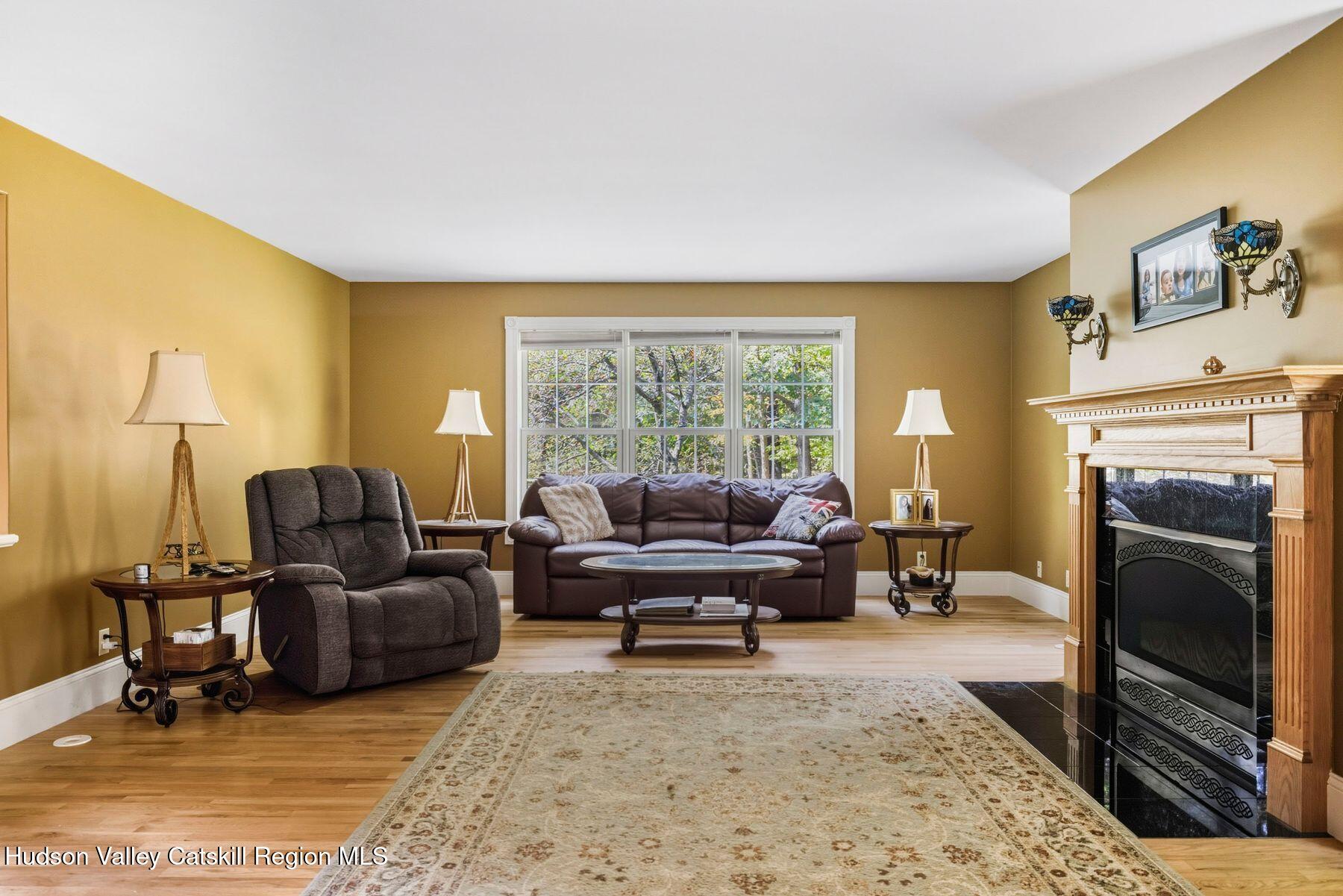 74 Bellevue Road Highland, NY 12528 - Photo 10 of 65 a living room with furniture and a fireplace
