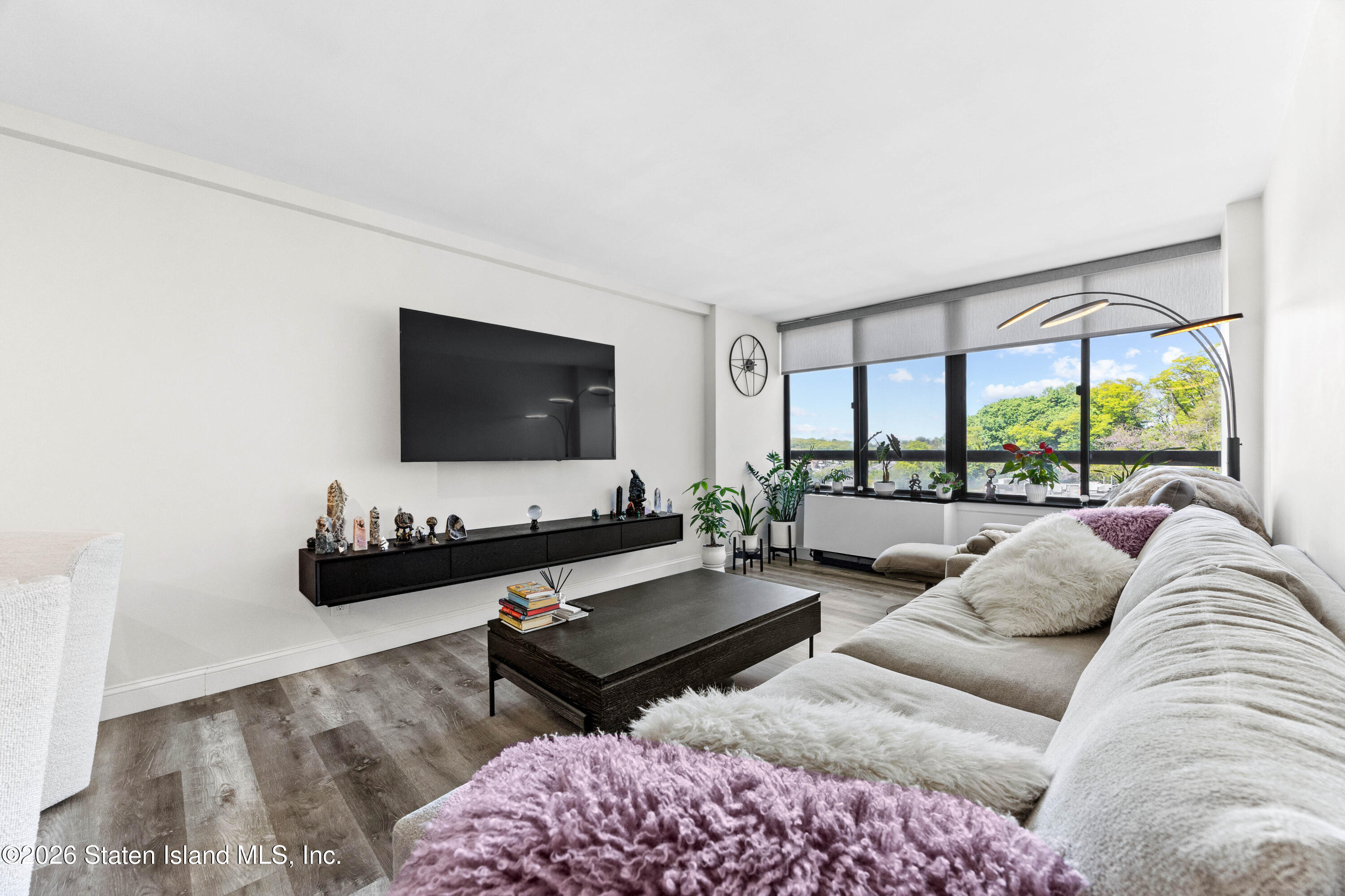 755 Narrows Road North, Unit 1014 Staten Island, NY 10304 - Photo 11 of 24 a living room with furniture and a flat screen tv