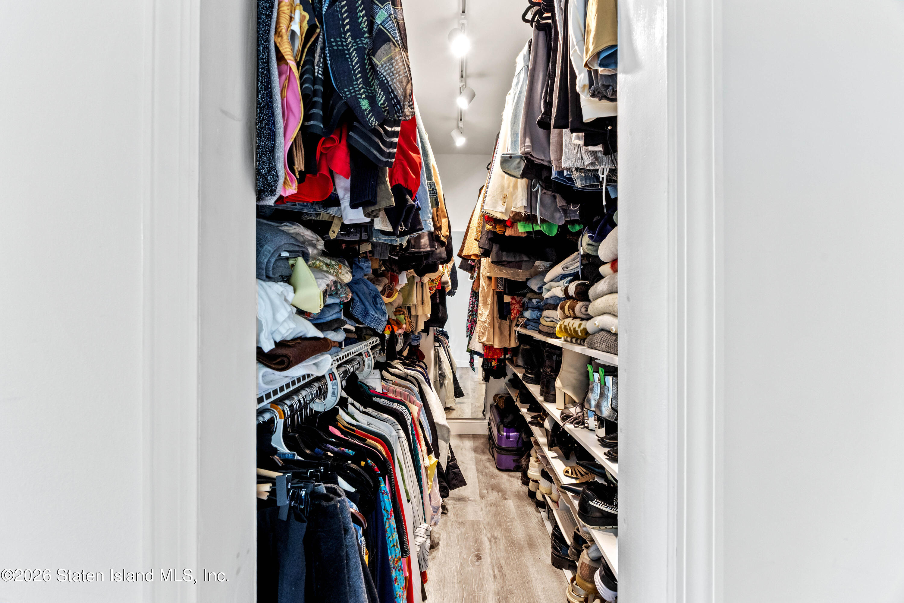 755 Narrows Road North, Unit 1014 Staten Island, NY 10304 - Photo 12 of 24 a view of walk in closet with clothes and shoes