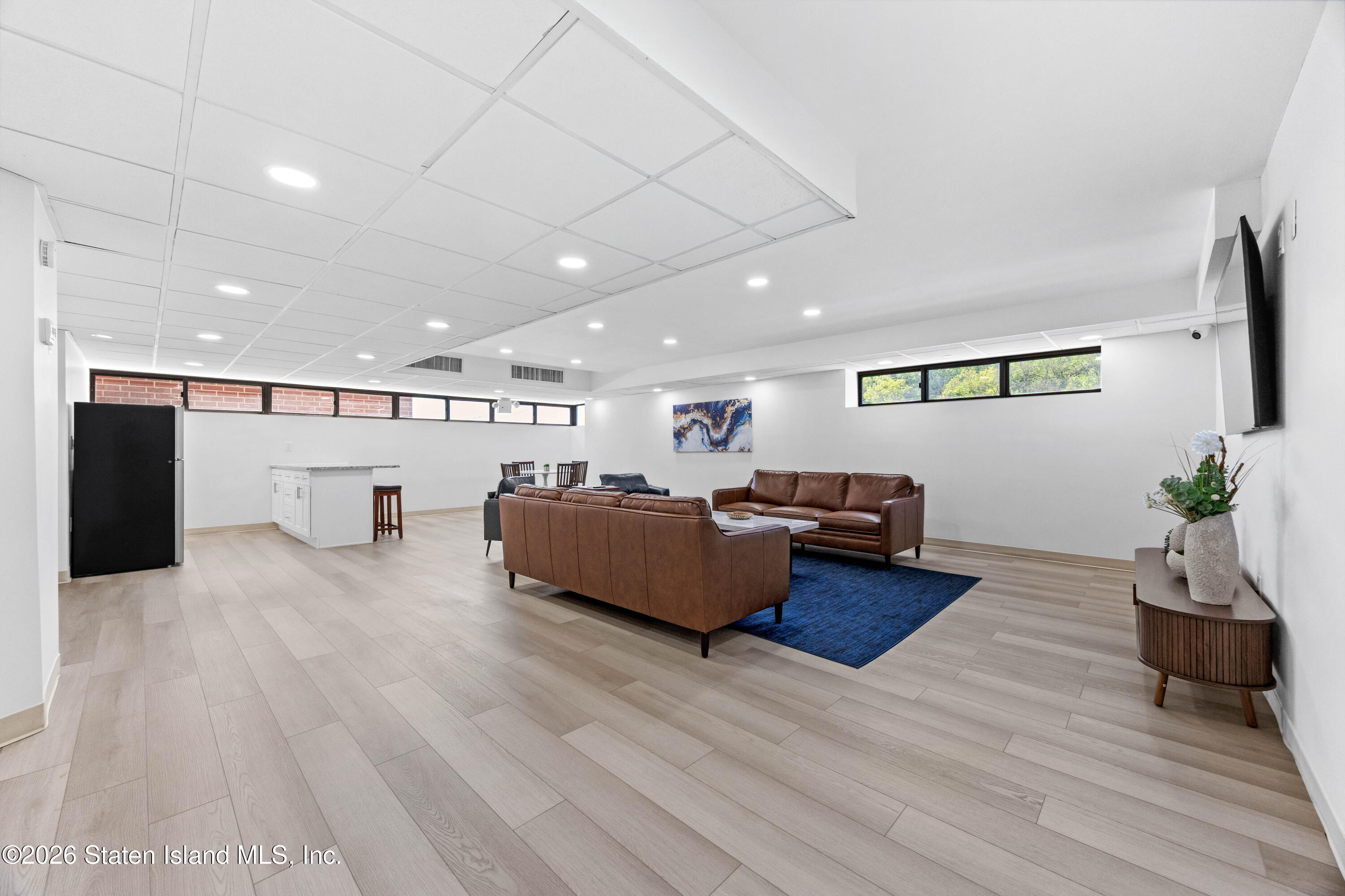 755 Narrows Road North, Unit 1014 Staten Island, NY 10304 - Photo 16 of 24 a living room with furniture and a wooden floor