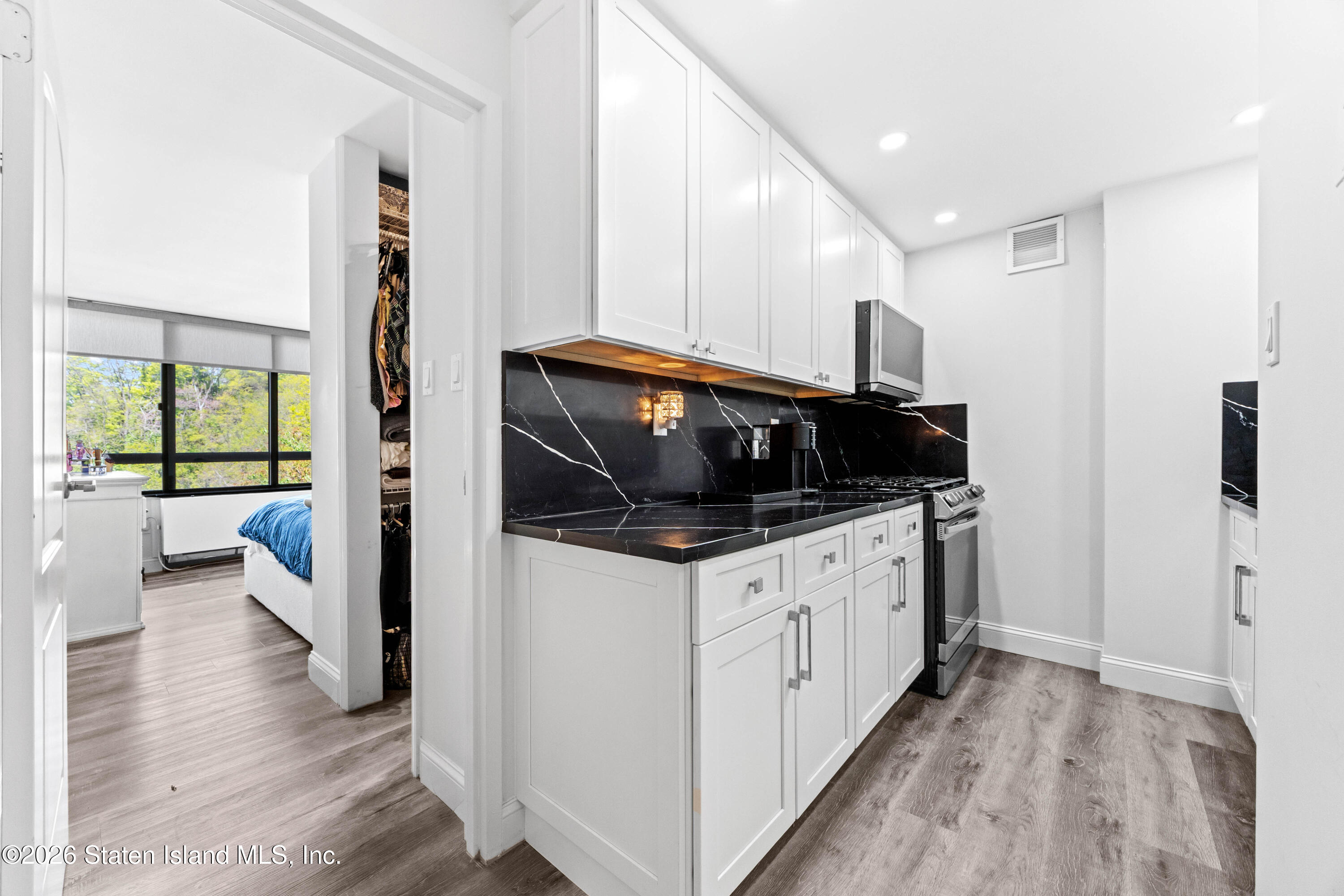 755 Narrows Road North, Unit 1014 Staten Island, NY 10304 - Photo 4 of 24 a kitchen with stainless steel appliances a stove a sink and a refrigerator