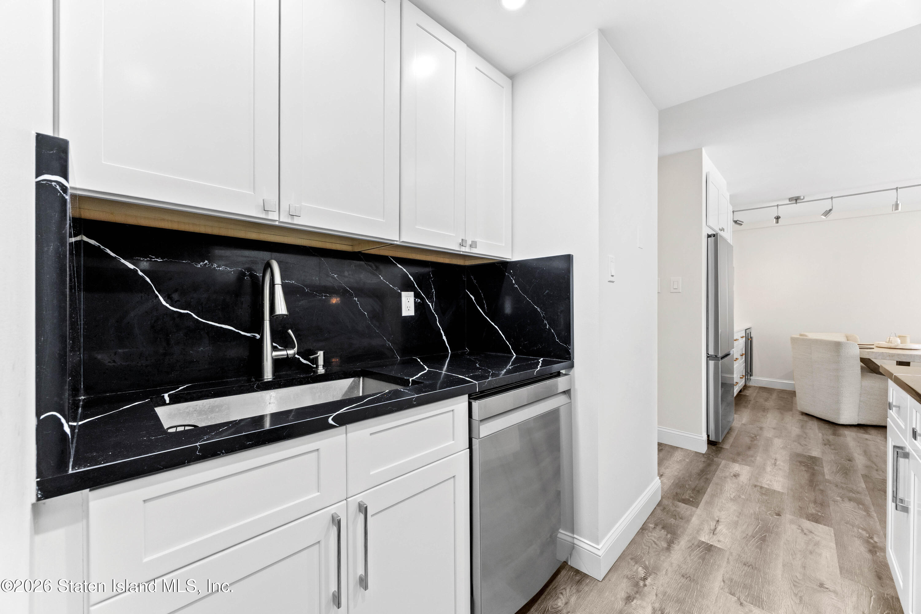 755 Narrows Road North, Unit 1014 Staten Island, NY 10304 - Photo 5 of 24 a kitchen with white cabinets and sink