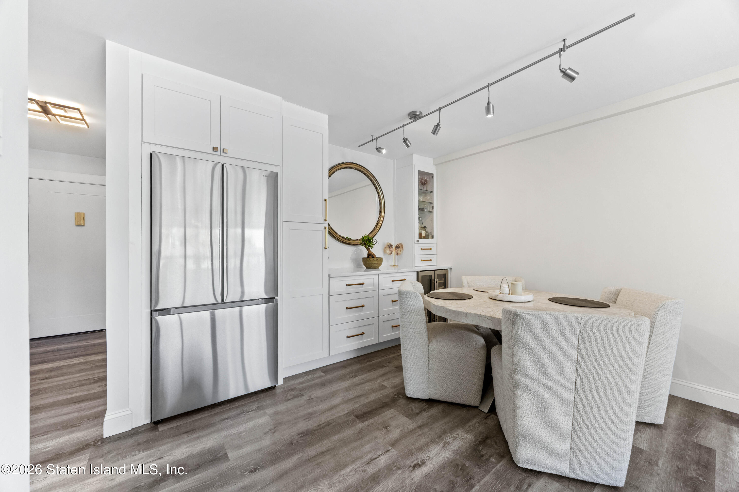 755 Narrows Road North, Unit 1014 Staten Island, NY 10304 - Photo 7 of 24 a kitchen with white cabinets and stainless steel appliances