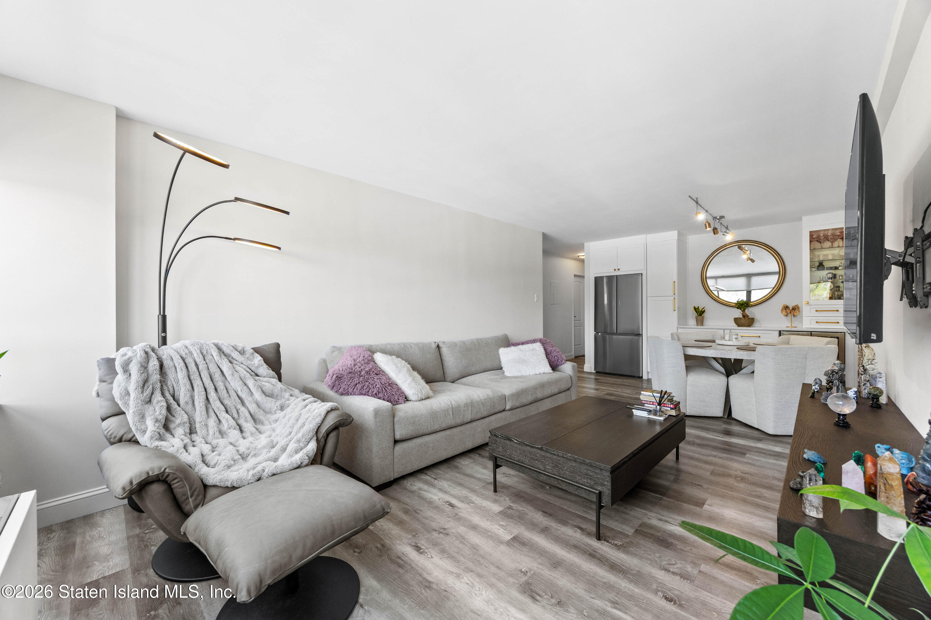 755 Narrows Road North, Unit 1014 Staten Island, NY 10304 - Photo 9 of 24 a living room with furniture a rug and a window