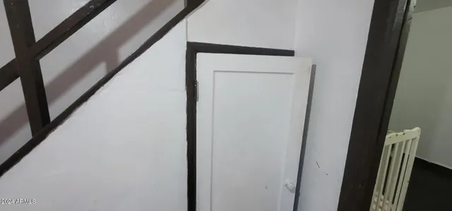 a bed sitting in a bedroom next to a window