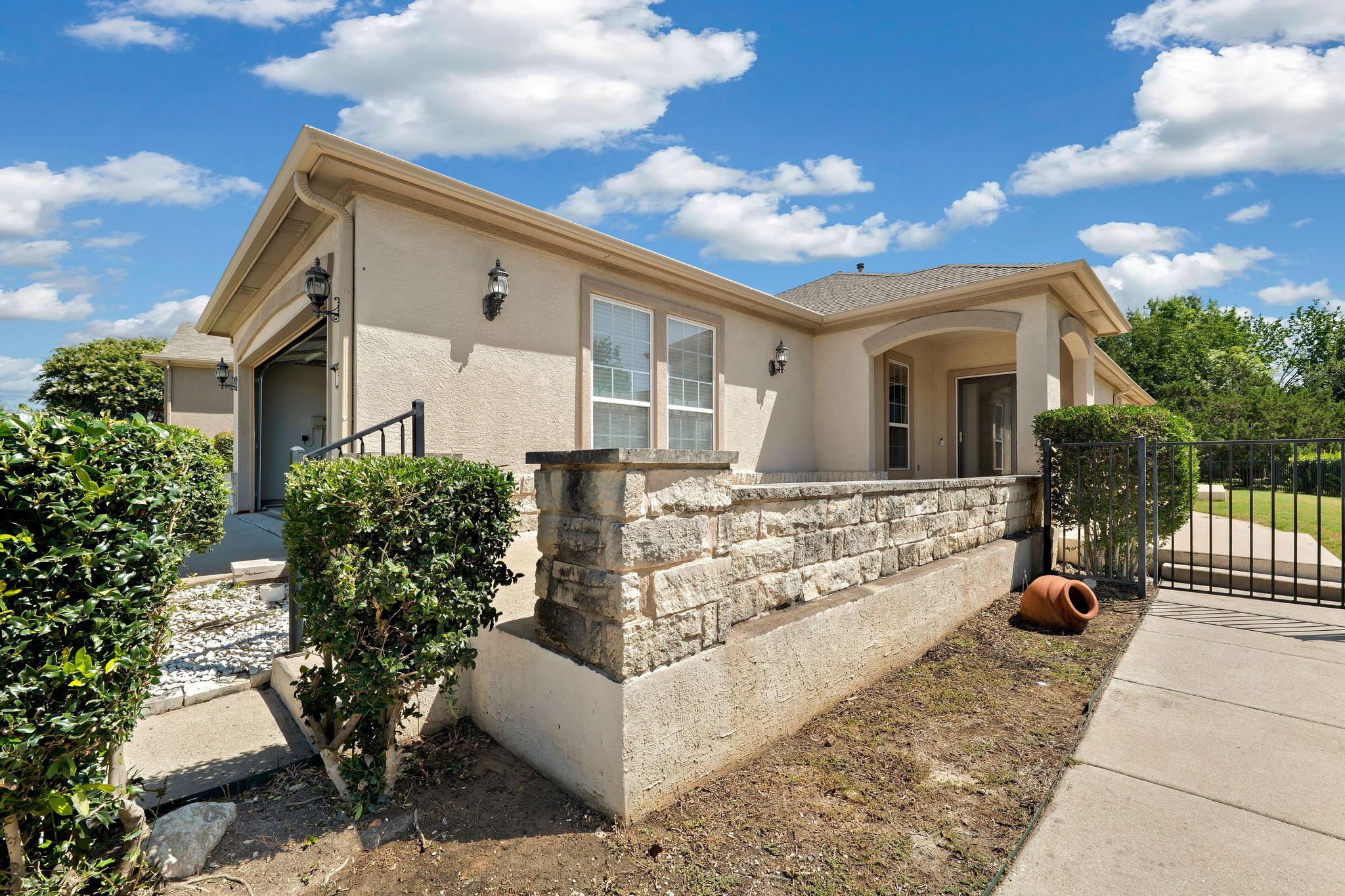 520 Mill Pond Path Georgetown, TX 78633 - Photo 6 of 38 A welcoming front entrance featuring a stone accent wall and covered patio invites residents inside.