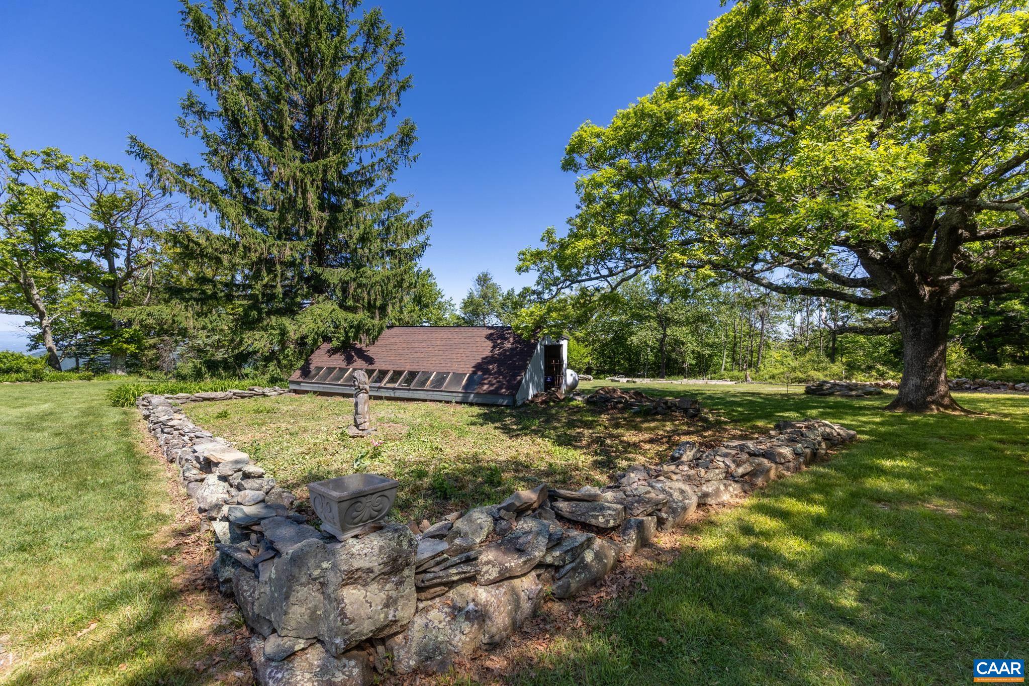 7098 Bucks Elbow Mountain Road Crozet, VA 22932 - Photo 42 of 57 a backyard of a house with a yard and outdoor seating