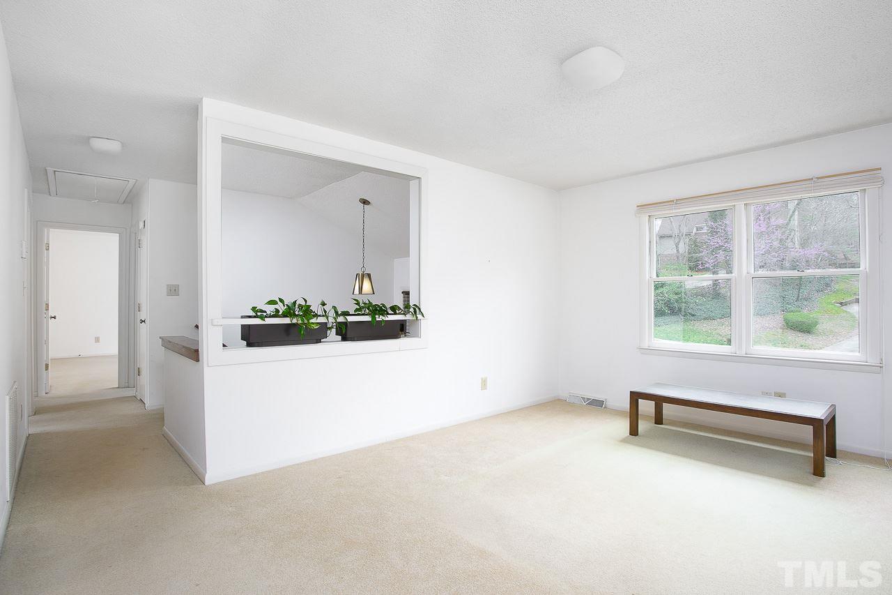 6324 Rushingbrook Drive Raleigh, NC 27612 - Photo 3 of 17 wooden floor in an empty room with a window