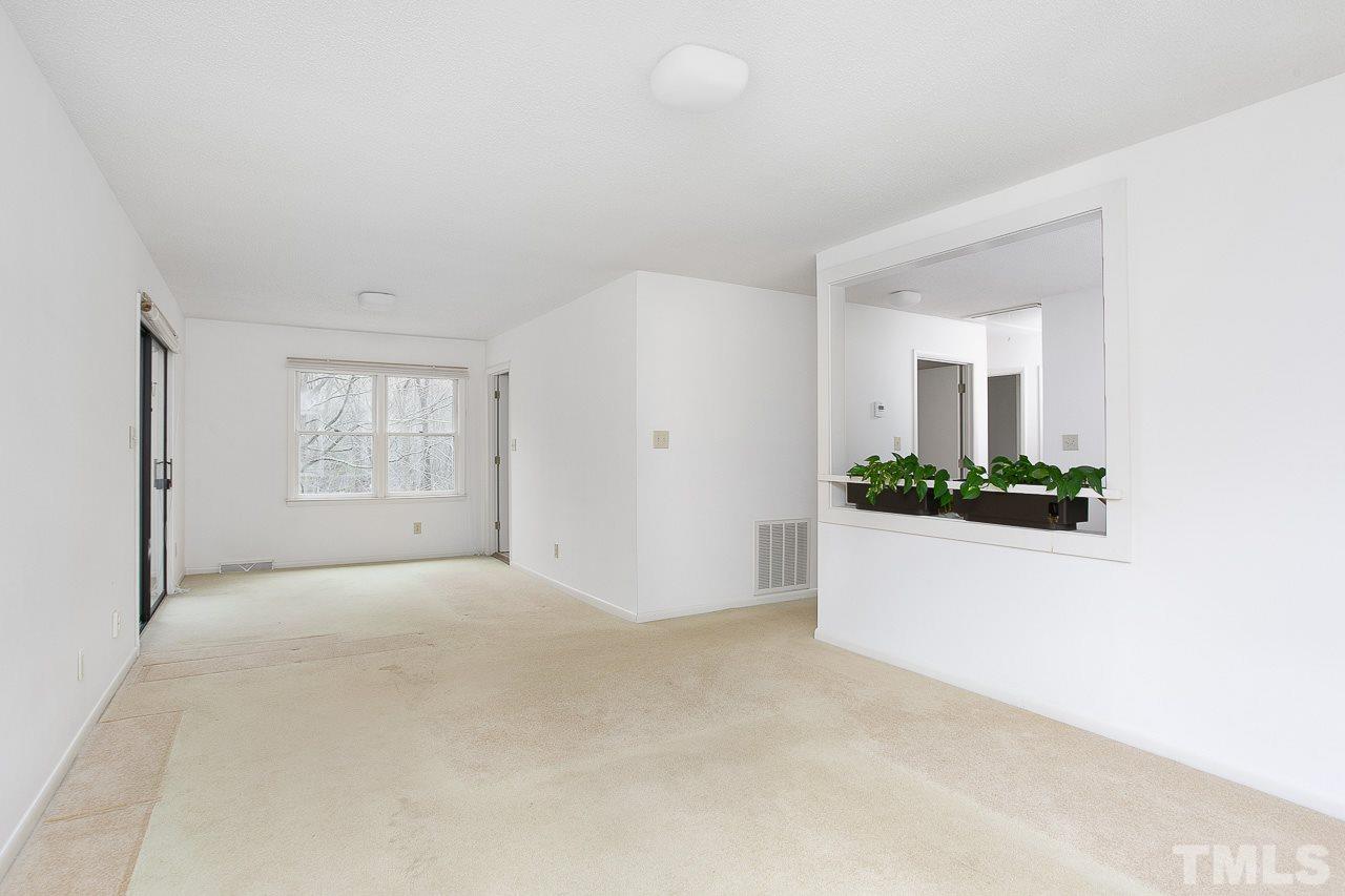 6324 Rushingbrook Drive Raleigh, NC 27612 - Photo 4 of 17 a view of an empty room with window and cabinet