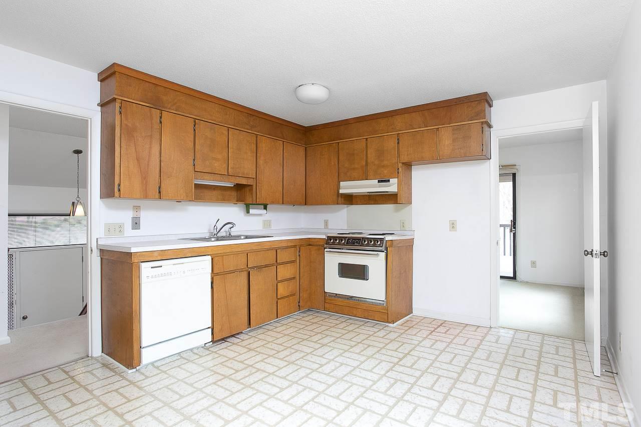 6324 Rushingbrook Drive Raleigh, NC 27612 - Photo 6 of 17 a kitchen with stainless steel appliances granite countertop a refrigerator sink and cabinets