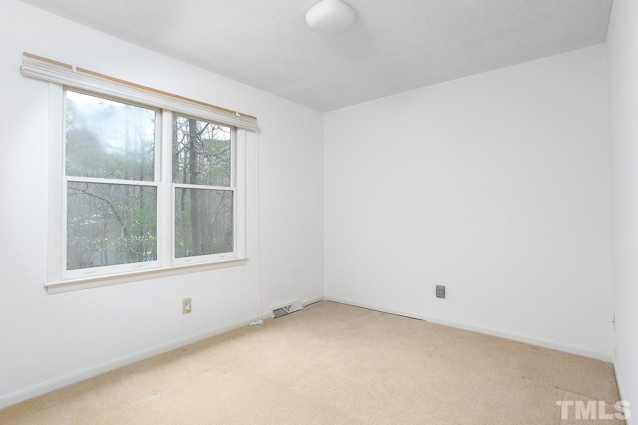 6324 Rushingbrook Drive Raleigh, NC 27612 - Photo 8 of 17 an empty room with a window