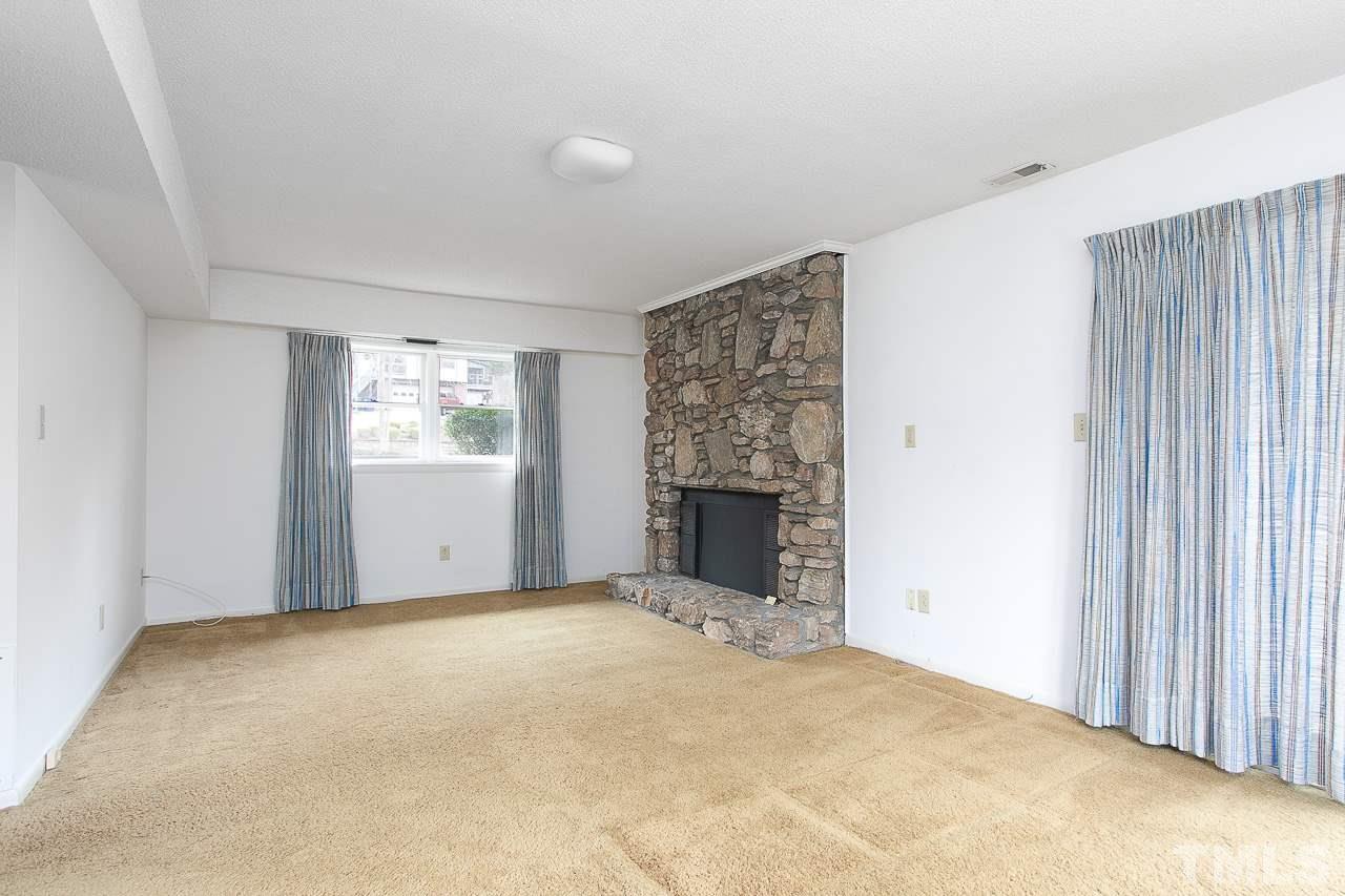 6324 Rushingbrook Drive Raleigh, NC 27612 - Photo 9 of 17 a view of an empty room with a fireplace